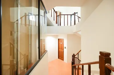 a staircase in a house with a glass wall at Snap Sukhumvit 1 - Bangkok City