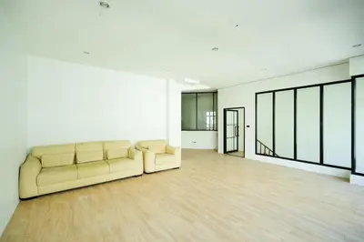 a large living room with a couch in the middle at Snap Sukhumvit 1 - Bangkok City