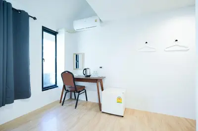 a room with a desk and a chair and a table at Snap Sukhumvit 1 - Bangkok City
