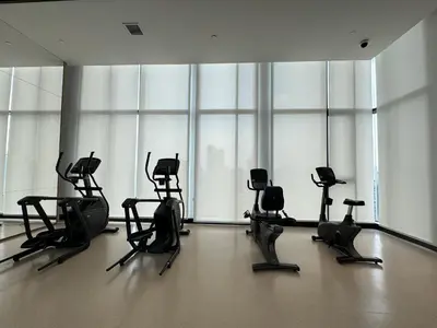 a gym with a bunch of chairs in a room at NUE District Rama 9 Condo in Bangkok