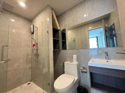 a bathroom with a toilet and a sink and a shower at NUE District Rama 9 Condo in Bangkok