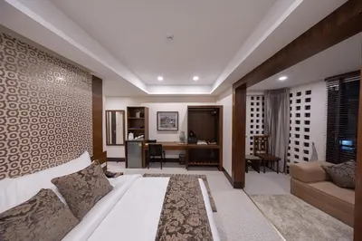 a living room with a couch and a desk at Casa Le Damuz in Bangkok