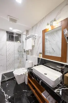 a bathroom with a white sink and a mirror at Casa Le Damuz in Bangkok