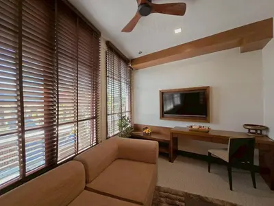a living room with a couch and a flat screen tv at Casa Le Damuz in Bangkok