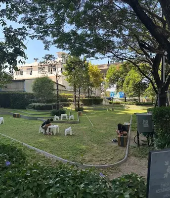 two people sitting in chairs in a park at Idea Labs Luxury Condo Coworking spaces in Ban Khlong Samrong
