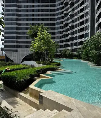 a swimming pool in front of a tall building at Idea Labs Luxury Condo Coworking spaces in Ban Khlong Samrong