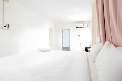 a white bedroom with a bed and a mirror at Oh My Nap Sukhumvit Soi 3 - คลองเตยเหนือ in Makkasan