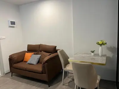 a living room with a couch and a table at Wutthakat high-rise exterior view room in Bangkok