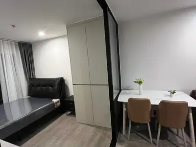 a room with a bed and a table and chairs at Wutthakat high-rise exterior view room in Bangkok