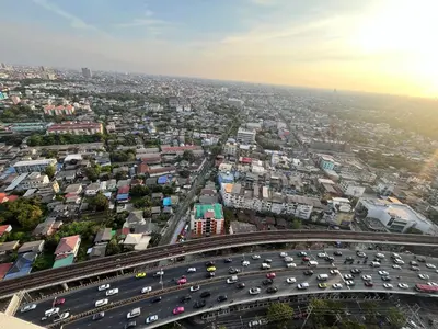 an overhead view of a busy highway with traffic at Wutthakat high-rise exterior view room in Bangkok