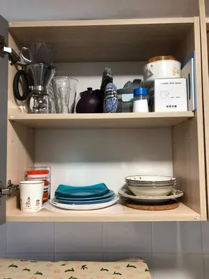 a shelf with plates and other dishes on it at BTS skytrain Phra Khanong Happy Place 1bedroom with office set in Bangkok