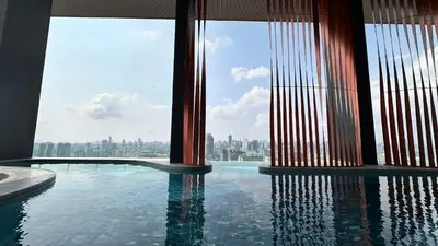 a swimming pool with a view of a city at Lovely home 2 in Ban Na Song