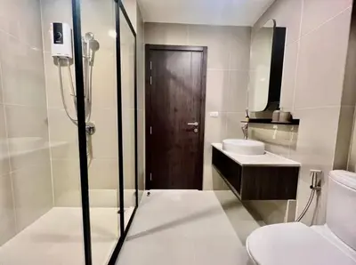 a bathroom with a shower and a toilet and a sink at Lovely home 2 in Ban Na Song