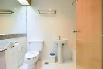 a bathroom with a toilet and a sink at Wish Inn Chidlom - Ratchadamri Bangkok in Pratunam