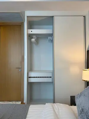 a bedroom with a bed and a glass door at Cozy City BTS Nana | Pool, Sauna & Gym 38th Floor in Makkasan