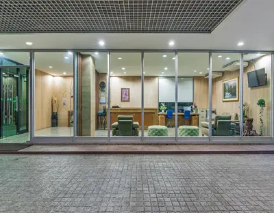 a lobby of a building with glass windows at BB Garden Resort in Bangkok