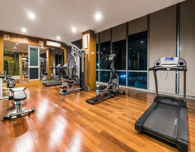 a gym with treadmills and exercise equipment in a building at BB Garden Resort in Bangkok