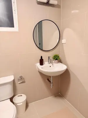 a bathroom with a sink and a mirror and a toilet at 166 Living in Bangkok
