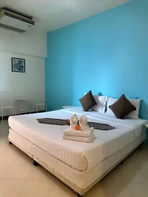 two stuffed animals sitting on a bed in a room at Private Apartment in city center and near BTS in Bangkok