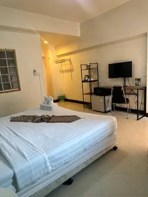 a bedroom with a large bed and a desk at Private Apartment in city center and near BTS in Bangkok