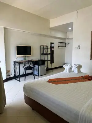 a bedroom with two beds and a desk and a television at Private Apartment in city center and near BTS in Bangkok
