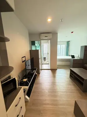 a large kitchen with a stove and a living room at Bangson Monthly rental apartment in Bang Su