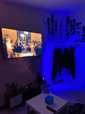 a living room with a blue room with a tv at High Friend Hostel in Phra Khanong