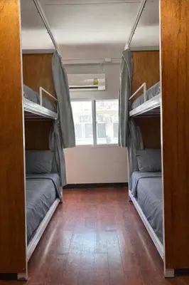 two bunk beds in a room with a mirror at High Friend Hostel in Phra Khanong