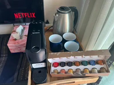 a box with cups and a kettle on a table at Walking distance to Sukhumvit soi 11 Netflix 40sqm in Makkasan