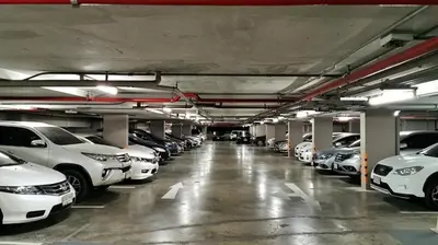 a parking garage filled with lots of parked cars at Walking distance to Sukhumvit soi 11 Netflix 40sqm in Makkasan