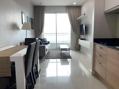 a living room with a couch and a table in a room at Walking distance to Sukhumvit soi 11 Netflix 40sqm in Makkasan