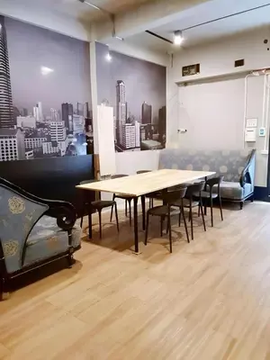 a conference room with a wooden table and chairs at GO INN Silom - BTS St Louis Bangkok in Yan Nawa