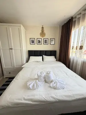 a white bed with two pairs of towels on it at Stadium Area Stay Famous Thai Street Food in Bangkok