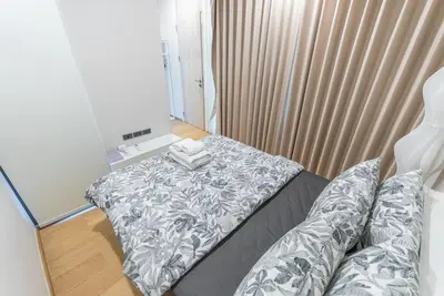 a bedroom with a bed and a mirror at Heaven Sukhumvit 62Villa in Bangkok