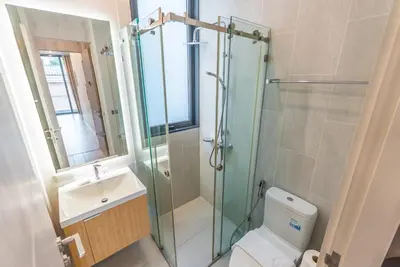 a bathroom with a shower and a toilet and a sink at Heaven Sukhumvit 62Villa in Bangkok