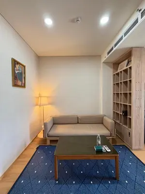 a living room with a couch and a coffee table at Sky Luxury Near BTS Ekkamai pool gym Netflix in Khlong Toei