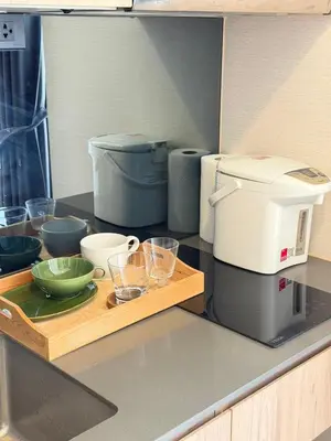 a kitchen with a coffee maker and bowls on a counter at Sky Luxury Near BTS Ekkamai pool gym Netflix in Khlong Toei