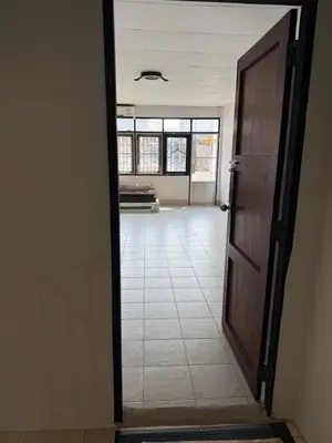 an open door to a room with a tile floor at Sleepben in Bangkok