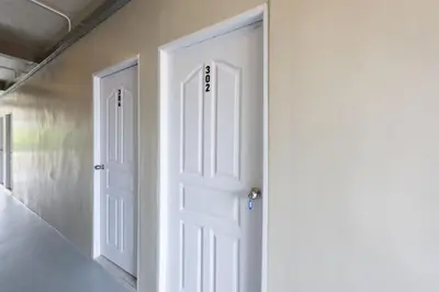 an open white door in a room with stairs at ดอนเมือง 308 Near DMK Airport BTS Wat PhraSi in Bang Khen
