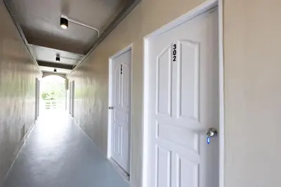 an empty hallway with a white door in a room at ดอนเมือง 308 Near DMK Airport BTS Wat PhraSi in Bang Khen