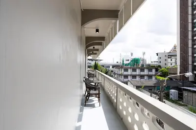 a chair sitting on the balcony of a building at ดอนเมือง 308 Near DMK Airport BTS Wat PhraSi in Bang Khen