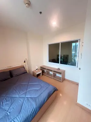 a bedroom with a bed and a large window at Luxury Apt BTS EKKAMAI with pool sauna gym in Bangkok