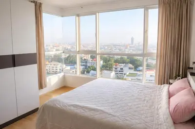a bedroom with a bed and a large window at Hive Sathorn SkyCorner Suite, BTS and 7-11 front in Bangkok