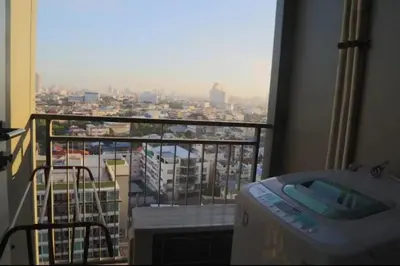 a room with a balcony with a view of a city at Hive Sathorn SkyCorner Suite, BTS and 7-11 front in Bangkok
