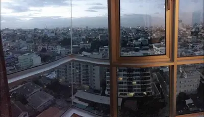 a view of a city from a large window at Hive Sathorn SkyCorner Suite, BTS and 7-11 front in Bangkok