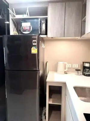 a kitchen with a black refrigerator and a counter at Modern 2BR-3 Mins Walking Distance to BTS Thonglor in Bangkok