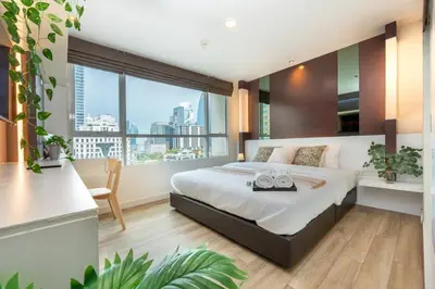 a bedroom with a large bed and a large window at Lucky 808 2BedRoom 100sqm BTS Chidlom in Bangkok