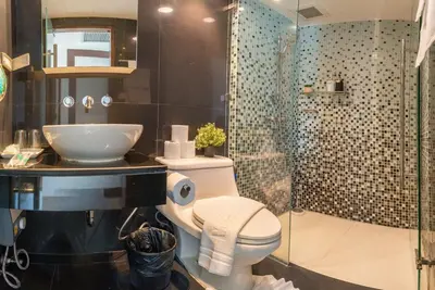 a bathroom with a toilet and a sink and a shower at Lucky 808 2BedRoom 100sqm BTS Chidlom in Bangkok