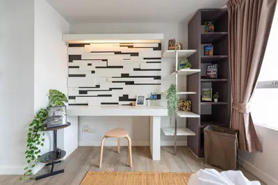a desk in a room with a wall at Lucky 808 2BedRoom 100sqm BTS Chidlom in Bangkok