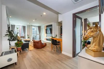 a living room with a statue of a horse on the wall at Lucky 808 2BedRoom 100sqm BTS Chidlom in Bangkok